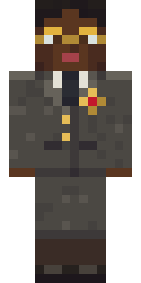 Defence Counsel, from the front: A sober grey-brown suit over a white blouse and narrow dark tie, the gold badge of the collegium of advocates, and round spectacles.